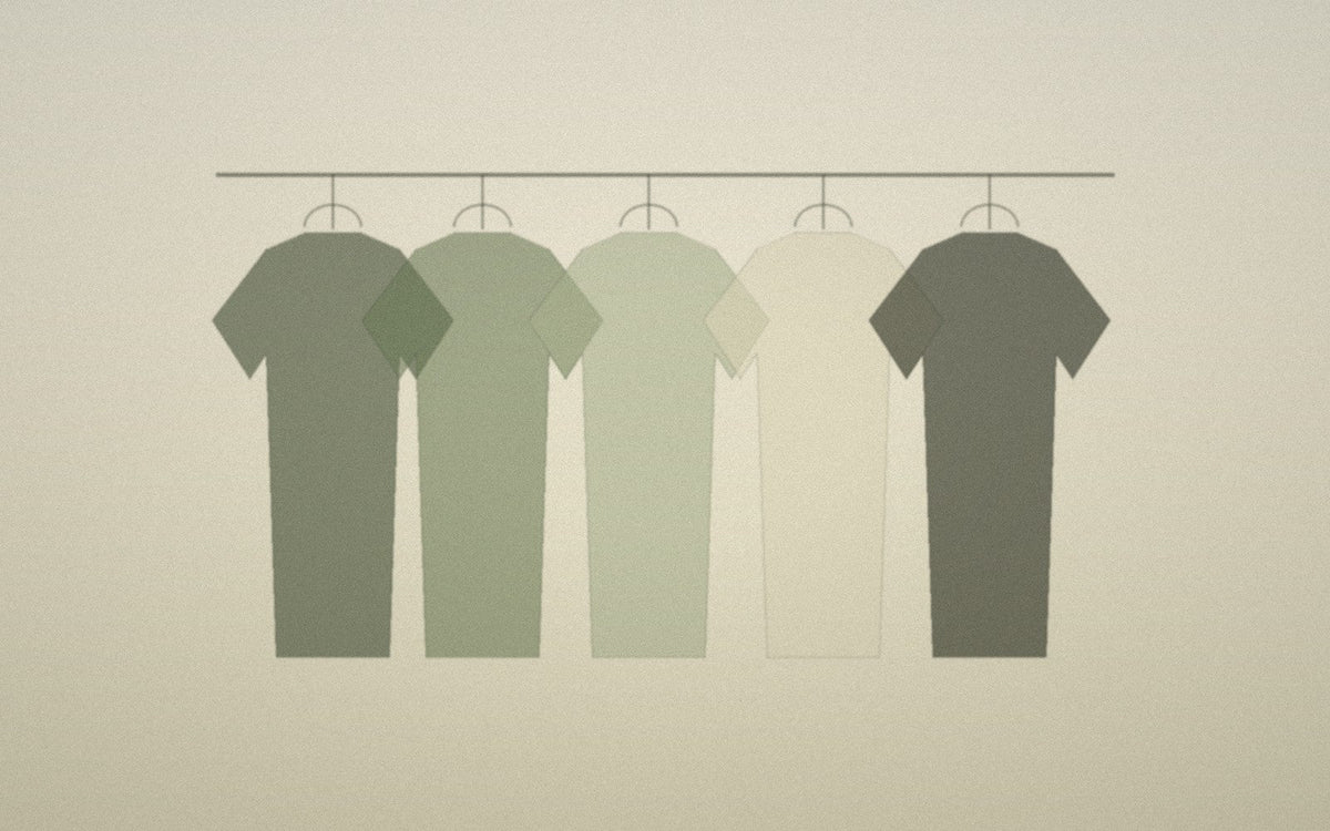 Minimal rail of a small deliberate wardrobe in quiet natural tones